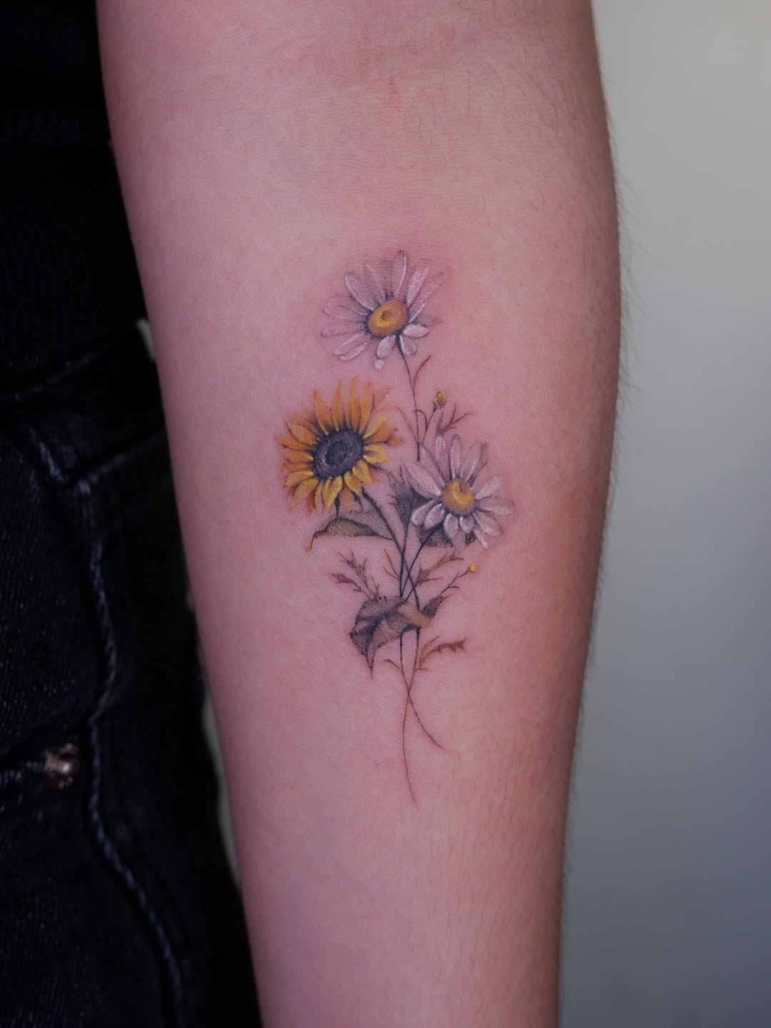 Permanent flowers fine line tattoo — the artistry of Needle House